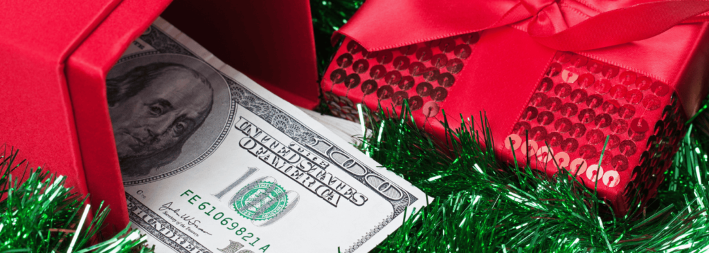 Cash inside a red envelope with a green gift box in the background, symbolizing holiday funding options.